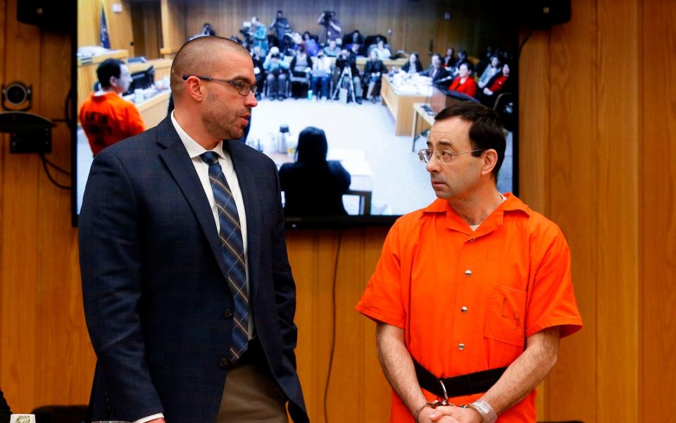 Former USA Gymnastics doctor Larry Nassar with his defence attorney Matt Newberg – Nassar is serving a life sentence for sexual assault - AFP