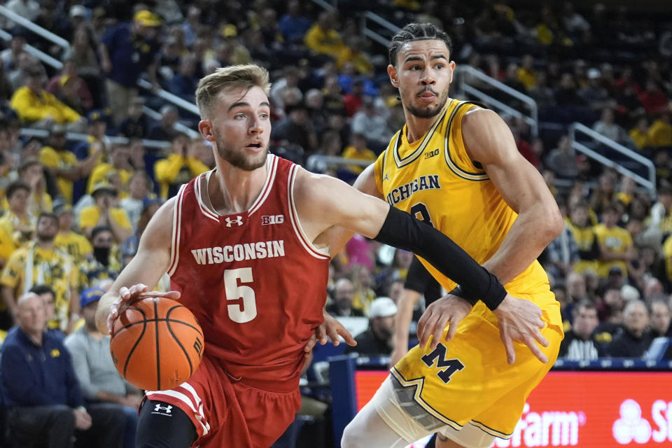 Wisconsin forward Tyler Wahl (5) drives on Michigan Wolverines forward Olivier Nkamhoua (13) in the first half of an NCAA college basketball game in Ann Arbor, Mich., Wednesday, Feb. 7, 2024. (AP Photo/Paul Sancya)