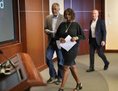 Minneapolis residents Sondra Samuels, front, her husband, Don Samuels, left, and businessman Bruce Dachis, right, walk to the podium for the start of a press conference to discuss where the situation stands regarding language on the future of the Minneapolis policing ballot Wednesday, Sept. 15, 2021, in Minneapolis. A judge struck down ballot language last week that aimed to replace the Minneapolis Police Department with a new agency, which sent the City Council scrambling to approve new language that members hope will stand up. The injunction to keep the language off the ballot was sought by former City Council Member Samuels, his wife, and Dachis. (David Joles/Star Tribune via AP)