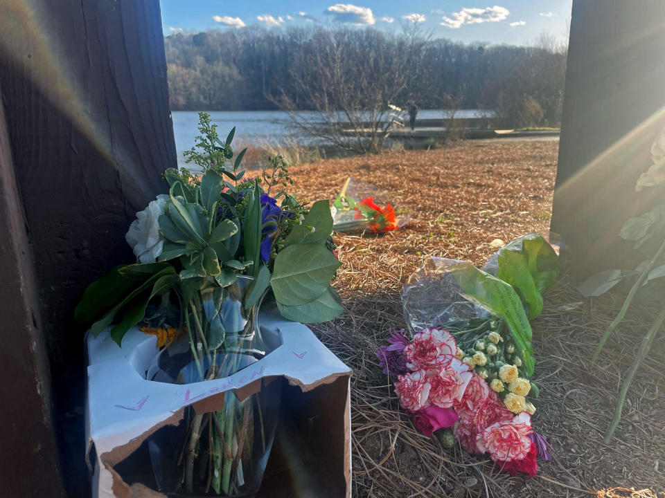 Flowers placed at a UGA campus memorial at Lake Herrick in Georgia. (Marissa Parra / NBC News)