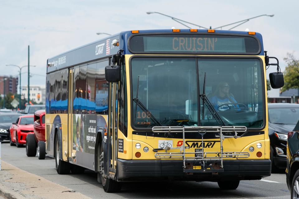 A SMART bus slowly moves with traffic as classic and modern vehicles cruise on Woodward Avenue in Birmingham during the annual Woodward Dream Cruise on Saturday, August 20, 2022.