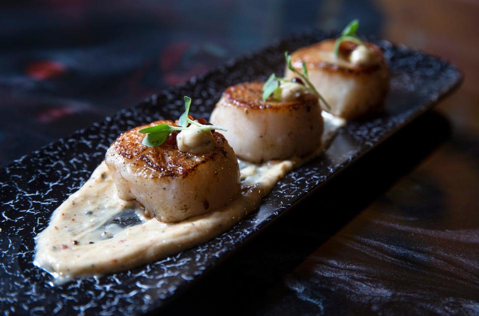 Seared scallops with tagarashi, aioli, scallions and avocado oil at Bad Hat Dumplings & Cocktails in Marlboro.