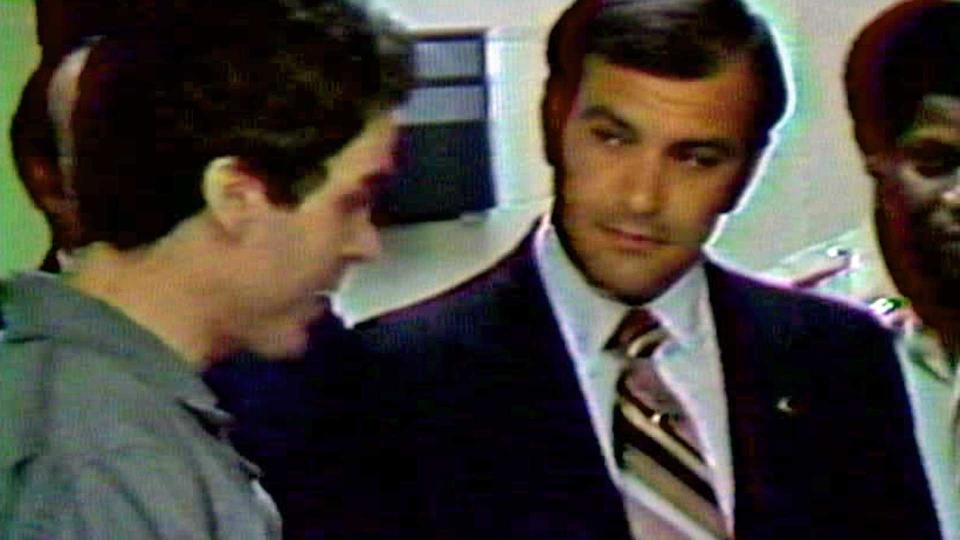 Ted Bundy, left, listens the Leon County Sheriff Ken Katsaris reads the indictment against him. / Credit: CBS News