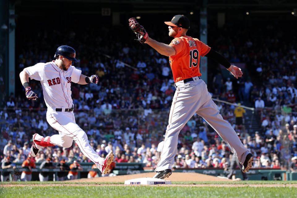 Baltimore Orioles first baseman Chris Davis (19) takes the throw for the out ahead of Boston Red Sox baserunner Chris Owings during the fourth inning of a baseball game, Saturday, Sept. 28, 2019, in Boston. (AP Photo/Mary Schwalm)