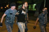 Armenian police detain opposition supporters blocking a street to a police station seized by gunmen in Yerevan, late on July 29, 2016