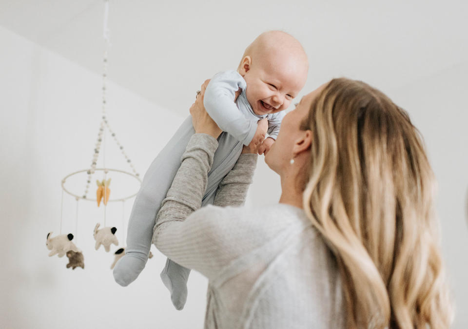 Mother holding her baby up in the air