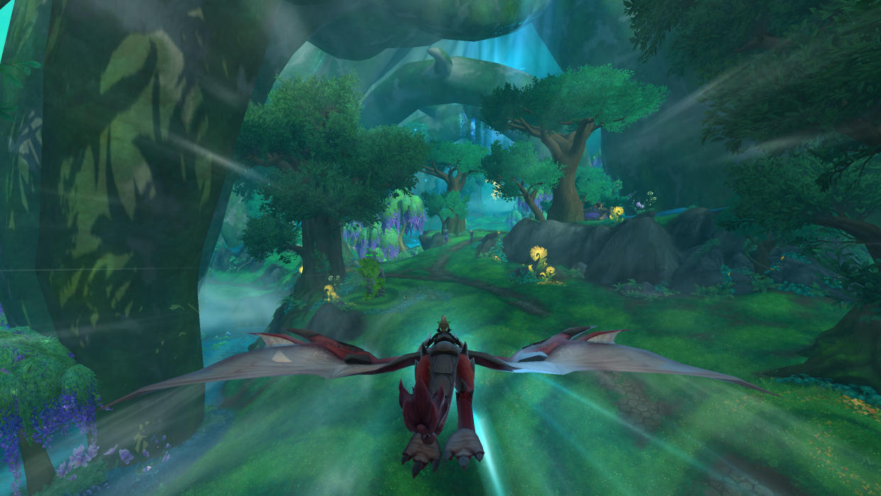  WoW Dragon Glyph locations - a dragon flies through a lush green forested area with a player riding on their back. 