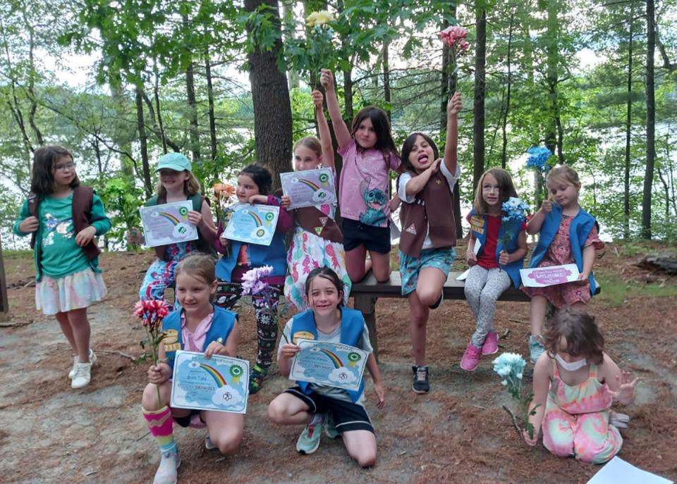 Girl Scouts in Troop 62357 participated in a year-end ceremony to welcome new members, bridge from Daisy to Brownie and Brownie to Junior. They went for a hike with their families, followed by the ceremony.