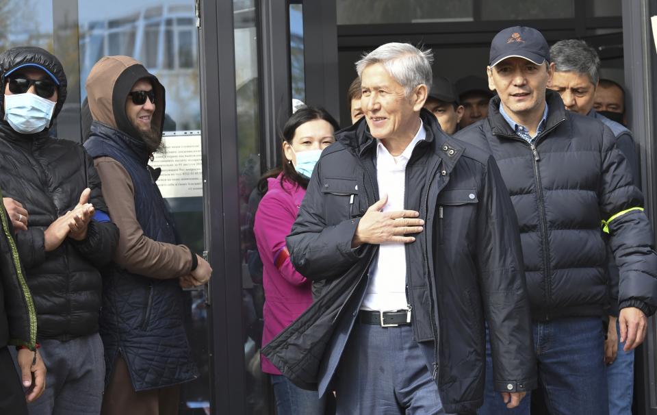 Former President Almazbek Atambayev waves to his supporters in Bishkek, Kyrgyzstan, Friday, Oct. 9, 2020. Sooronbai Jeenbekov, the embattled president of Kyrgyzstan, has moved to end the political turmoil that followed a disputed parliamentary election, ordering a state of emergency in the capital. Jeenbekov has faced calls to resign by protesters who stormed government buildings after Sunday’s parliamentary vote was reportedly swept by pro-government parties. Protesters freed former President Almazbek Atambayev, who was jailed on charges seen by his supporters as a political vendetta. (AP Photo/Vladimir Voronin)