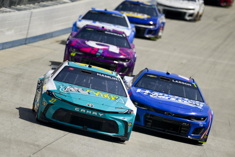 Denny Hamlin leads Kyle Larson into Turn 1 during a NASCAR Cup Series auto race at Dover Motor Speedway, Sunday, April 28, 2024, in Dover, Del. (AP Photo/Derik Hamilton)