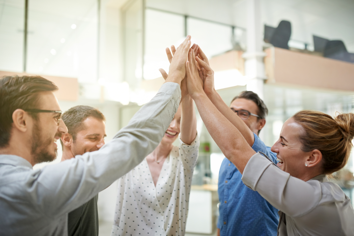 Employee huddle giving high-fives