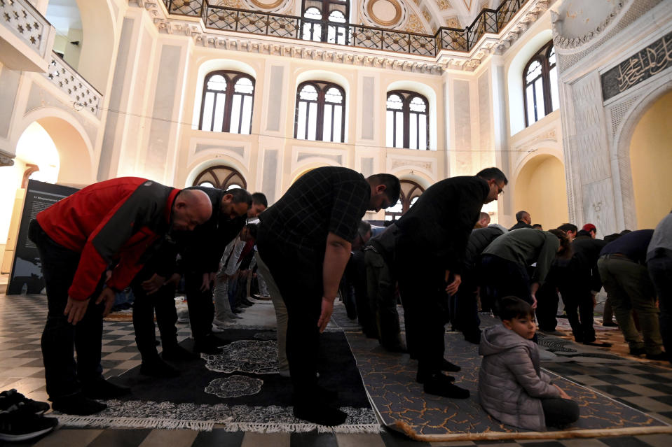 People pray at the historic Yeni Cami, or New Mosque, in the port city of Thessaloniki, northern Greece, Wednesday, April 10, 2024. Eid prayers held in the historic former mosque in northern Greece for the first time in 100 years. (AP Photo/Giannis Papanikos)