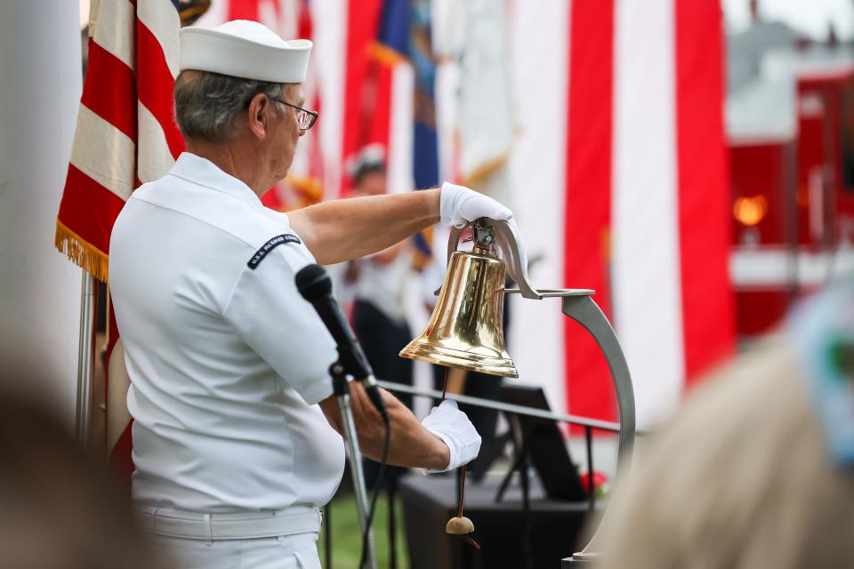 United States Navy retired Petty Officer Joseph "Joe" Kutt tolls the bell for each N.H. solder who gave their life in the Global War on Terrorism on Sept. 11, 2022, in Hampton.