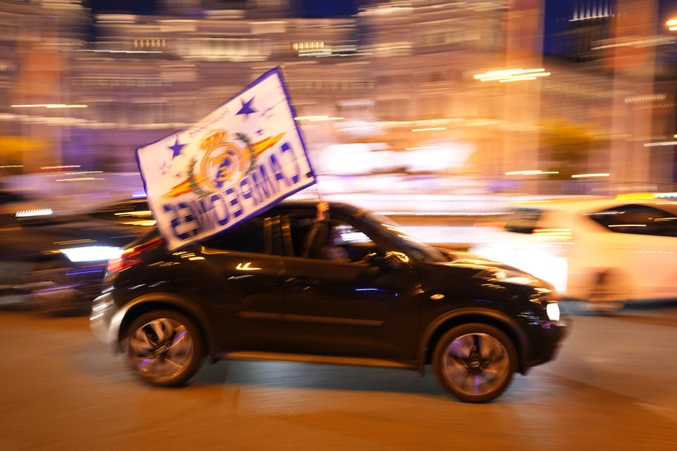 Real Madrid supporters celebrate in Cibeles Square in Madrid after their team clinched the La Liga title, Saturday, May 4, 2024. Real, who had won earlier in the day, clinched the title after Barcelona failed to beat Girona. (AP Photo/Manu Fernandez)