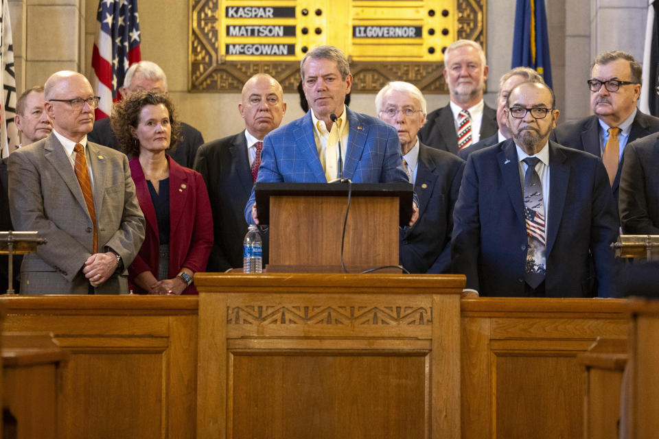 Gov. Jim Pillen (center) is joined by state senators as he announces that the state will participate in the Summer Electronic Benefits Transfer Program after previously saying Nebraska wouldn't take part during a press conference in the Warner Chamber at the Capitol, Monday, Feb. 12, 2024, in Lincoln, Neb. (Kenneth Ferriera/Lincoln Journal Star via AP)