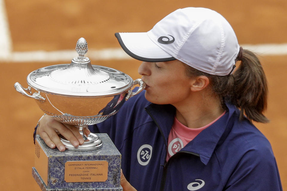 Poland's Iga Swiatek kisses the winner's trophy after defeating Czech Republic's Karolina Pliskova at the final match of the Italian Open tennis tournament, in Rome, Sunday, May 16, 2021. Swiatek won 6-0, 6-0. (AP Photo/Gregorio Borgia)