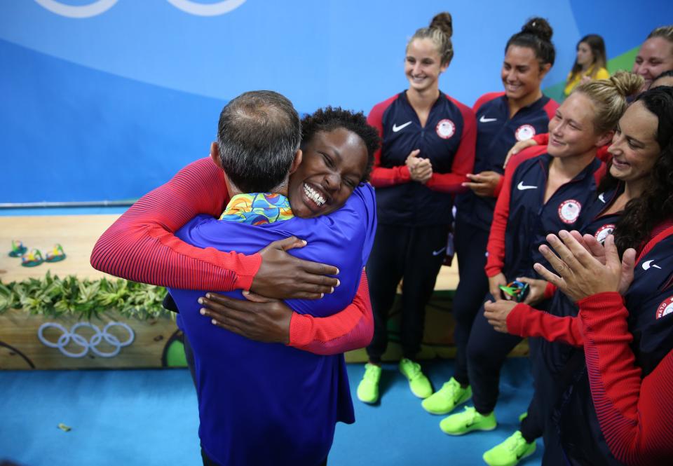 Ashleigh Johnson embraces coach Adam Krikorian in the women's water polo medal ceremony at Olympic Aquatics Stadium during the Rio 2016 Summer Olympic Games.