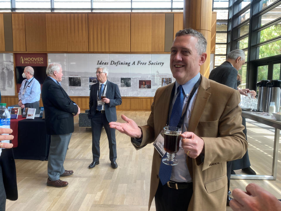 Federal Reserve Bank of St. Louis President James Bullard chats, during a break at a conference on monetary policy at Stanford University's Hoover Institution, in Palo Alto, California, U.S. May 6, 2022. Picture taken May 6, 2022. REUTERS/Ann Saphir