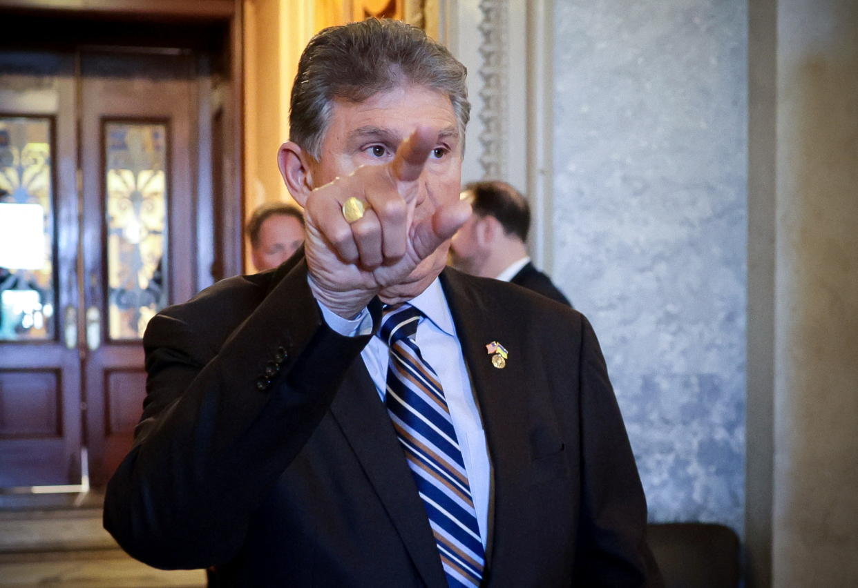 Senator Joe Manchin (D-WV) points towards an exit at the United States Capitol building in Washington, U.S., May 26, 2022. REUTERS/Evelyn Hockstein