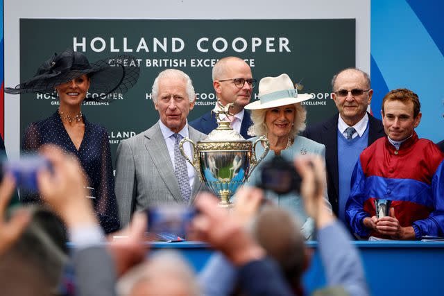 <p>BENJAMIN CREMEL/AFP via Getty</p> King Charles and Queen Camilla attend horse racing at Epsom Downs Racecourse on May 31, 2024