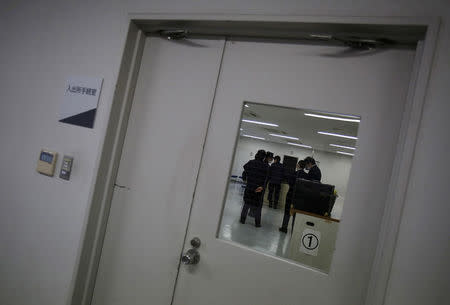 FILE PHOTO: Guards at the East Japan Immigration Center stand inside a processing room at the center in Ushiku, Ibaraki prefecture, Japan, March 19, 2015. REUTERS/Yuya Shino/File Photo