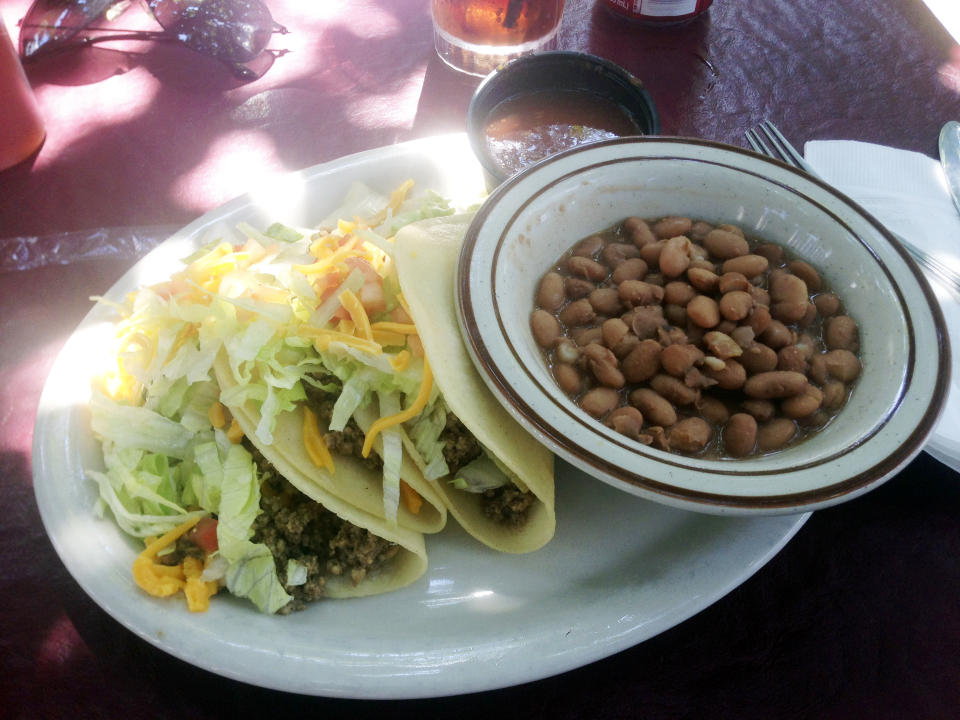 In this Sept 5, 2013 photo, a soft taco plate from El Patio de Albuquerque is shown. El Patio is a longtime, unpretentious eatery near Albuquerque’s University of New Mexico campus, and is one of the city’s most popular dining spots. For nearly four decades, multi-generational families, tourists, professors, students _ even celebrities _ have lined up outside this former house for robust but simple fare. (AP Photo/Russell Contreras)