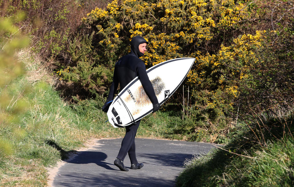 Only those within walking distance of the beach are allowed to surf, according to government guidelines (Owen Humphreys/PA)