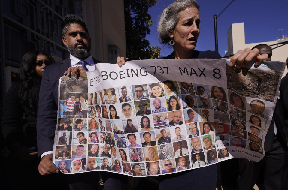 Naheed Noormohamed, left, son of Ameen Ismail Noormohamed, and Nadia Milleron, mother of Samya Stumo, carry photos photos of their family and others killed in the 2019 crash of Ethiopian Airlines 737 Max aircraft after the federal court arraignment of Boeing in Fort Worth, Texas, Thursday, Jan. 26, 2023.(AP Photo/LM Otero)