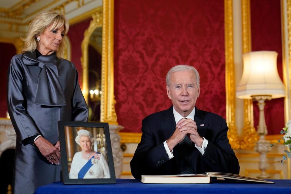 As first lady Jill Biden looks on President Joe Biden speaks after signing a book of condolence at Lancaster House in London, following the death of Queen Elizabeth II, Sept. 18, 2022.