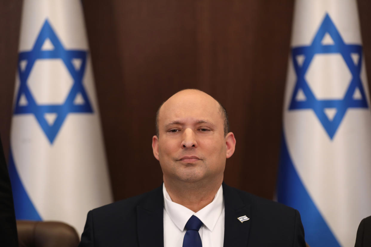 FILE - Israeli Prime Minister Naftali Bennett chairs a cabinet meeting at the prime minister's office in Jerusalem, Sunday, May 15, 2022. Bennett on Tuesday welcomed a recent decision to expand Jewish settlements in the occupied West Bank that the Palestinians and most of the international community view as illegal. (Abir Sultan/Pool Photo via AP, File)