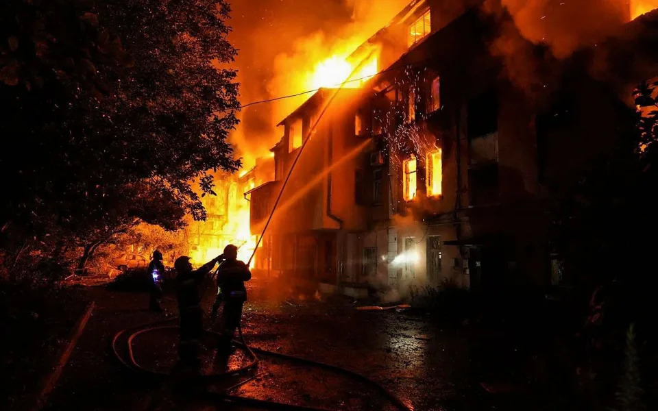 Ukrainian firefighters battle a blaze at a building which was struck by a rocket in the port city of Mykolaiv