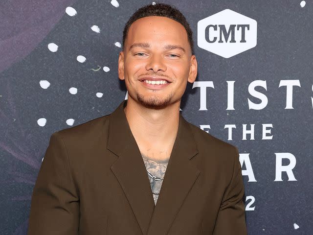 <p>Terry Wyatt/Getty</p> Kane Brown attends the 2022 CMT Artists Of The Year on October 12, 2022 in Nashville, Tennessee.