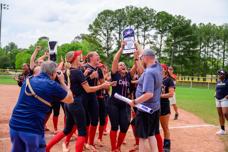 William Carey softball hoists a trophy after winning the 2024 Southern States Athletics Conference Tournament championship.