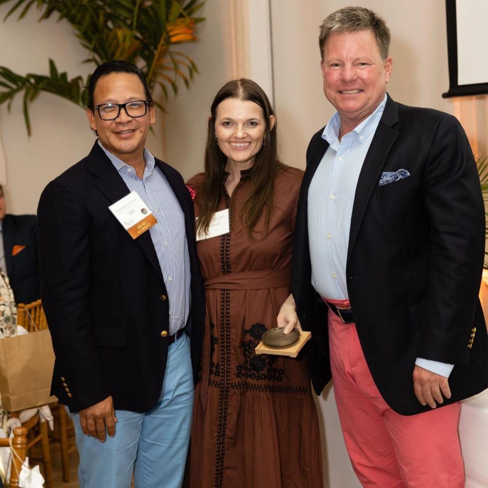 Fernando Wong, left, and Tim Johnson, right, of Fernando Wong Outdoor Living Design, with Kristin Kellogg, celebrate their award for landscape architecture at the 11th annual juried competition sponsored by the Florida chapter of the Institute of Classical Architecture & Art.