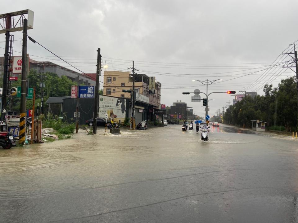 高雄市22日下午強降雨，造成燕巢區地勢低窪的橫水路一帶，即樹德科技大學前積水，車輛涉水穿越，險象環生。（民眾提供） 