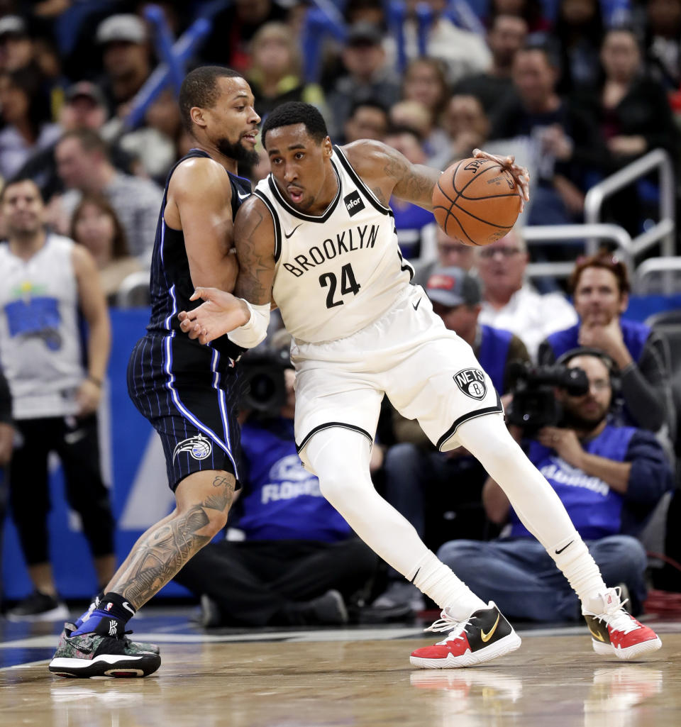 Brooklyn Nets' Rondae Hollis-Jefferson (24) moves to the basket as Orlando Magic's Isaiah Briscoe defends during the first half of an NBA basketball game Friday, Jan. 18, 2019, in Orlando, Fla. (AP Photo/John Raoux)