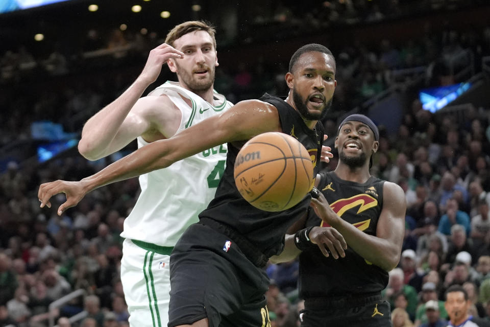 Cleveland Cavaliers forward Evan Mobley, center, and guard Caris LeVert, right, and Boston Celtics center Luke Kornet watch the ball get away during the first half of Game 2 of an NBA basketball second-round playoff series Thursday, May 9, 2024, in Boston. (AP Photo/Steven Senne)