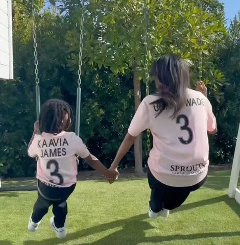 <p>Instagram/gabrielleunion</p> Gabrielle Union and her daughter Kaavia hold hands on a swing set for Mother's Day clip