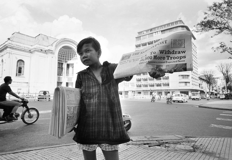 A Vietnamese newsboy sells newspapers in Saigon with the headline announcing the U.S. troop withdrawals hours before Pres. Nixon was slated to formally announce the withdrawals, Sept. 16, 1969.