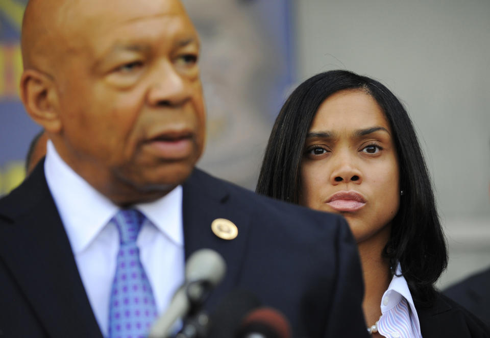 FILE - In this Aug. 3, 2015, file photo, State's Attorney Marilyn Mosby, right, listens as U.S. Rep. Elijah Cummings speaks during an announcement of the start of the Baltimore Federal Homicide Task Force, in Baltimore. Mosby is not the only Baltimore resident who relied on Cummings for advice. The congressman and civil rights advocate, who died Thursday, Oct. 17, 2019, at 68, mentored countless young people, faith leaders, activists, politicians and others throughout the years. (Lloyd Fox/The Baltimore Sun via AP, File)