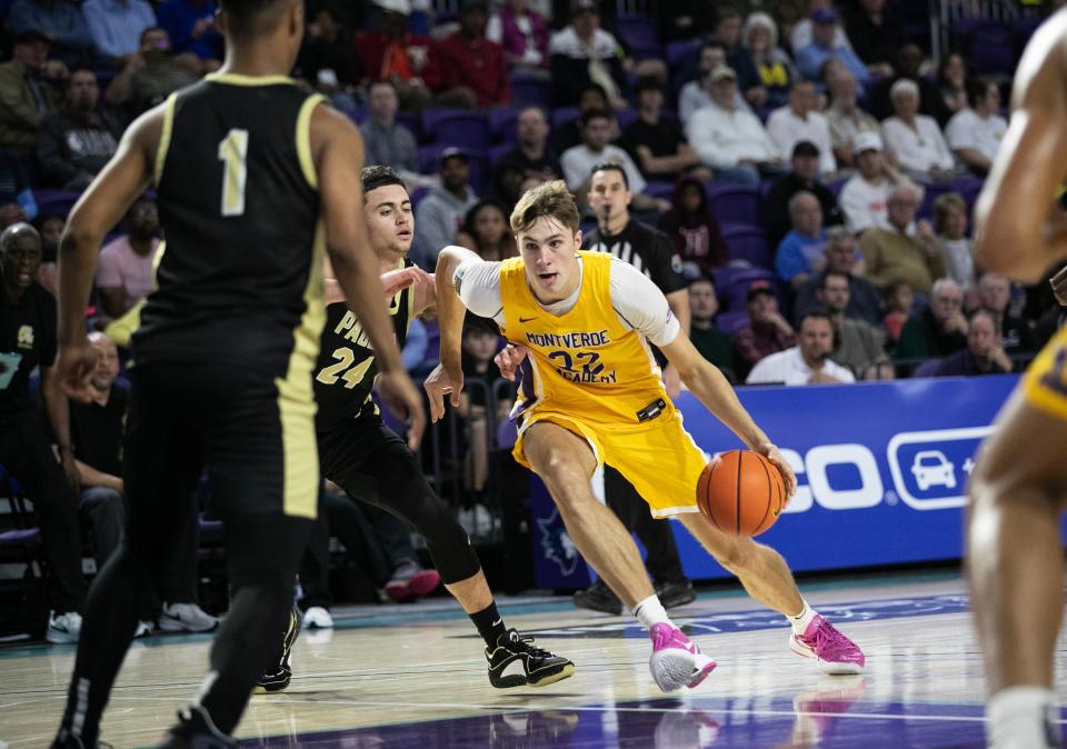 Cooper Flagg of Montverde Academy drives past Darren Harris of Paul VI at the City of Palms Classic on Friday, Dec. 22, 2023, at Suncoast Credit Union Arena in Fort Myers.