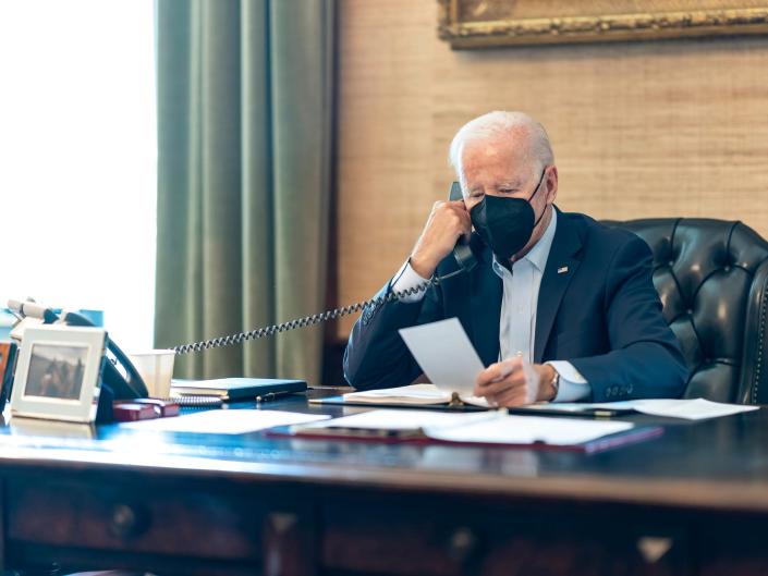 In this photo provided by The White House, President Joe Biden talks on the phone with his national security team from the Treaty Room in the residence of the White House in Washington, Friday, July 22, 2022.