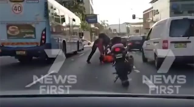 The motorbike rider can be seen allegedly attacking the elderly man. Source: Channel 7