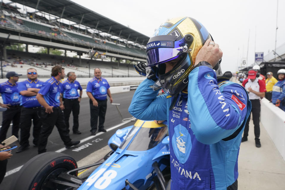 Jimmie Johnson takes off his helmet during qualifications for the Indianapolis 500 auto race at Indianapolis Motor Speedway, Saturday, May 21, 2022, in Indianapolis. (AP Photo/Darron Cummings)