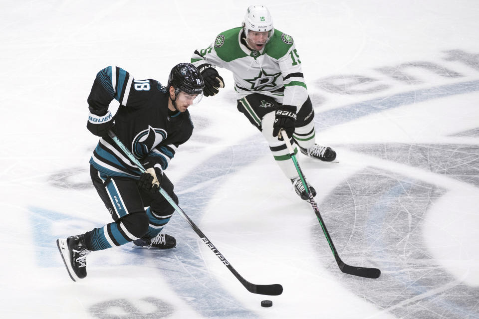 San Jose Sharks right wing Filip Zadina (18) and Dallas Stars center Craig Smith (15) vie for the puck during the third period of an NHL hockey game Tuesday, March 5, 2024, in San Jose, Calif. (AP Photo/Nic Coury)