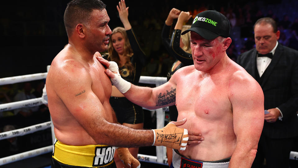 Justin Hodges and Paul Gallen embrace after their bout in September.