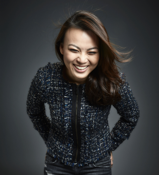 Porcelain founder Pauline Ng laughing with her hair flying and hands in pocket