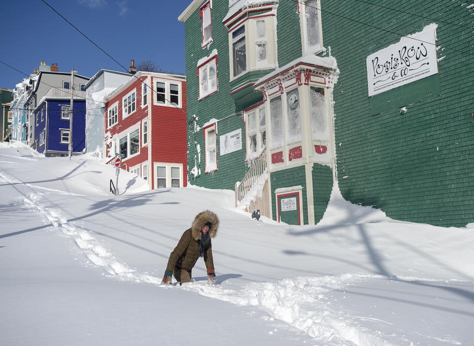 A residents makes their way through the snow in St. John's, Newfoundland on Saturday, Jan. 18, 2020. The state of emergency ordered by the City of St. John's is still in place, leaving businesses closed and vehicles off the roads in the aftermath of the major winter storm that hit the Newfoundland and Labrador capital. (Andrew Vaughan/The Canadian Press via AP)