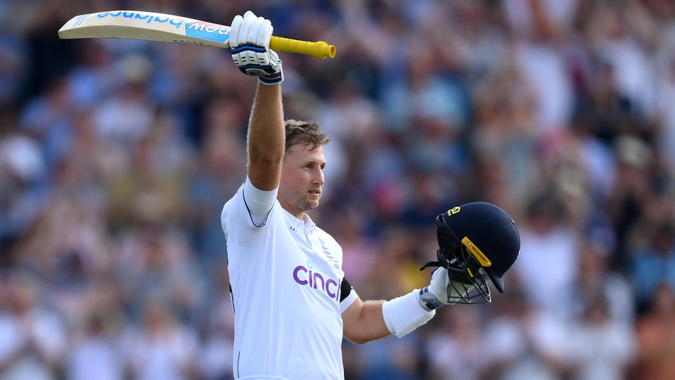 Joe Root raises his bat after hitting a century in the first Ashes Test.