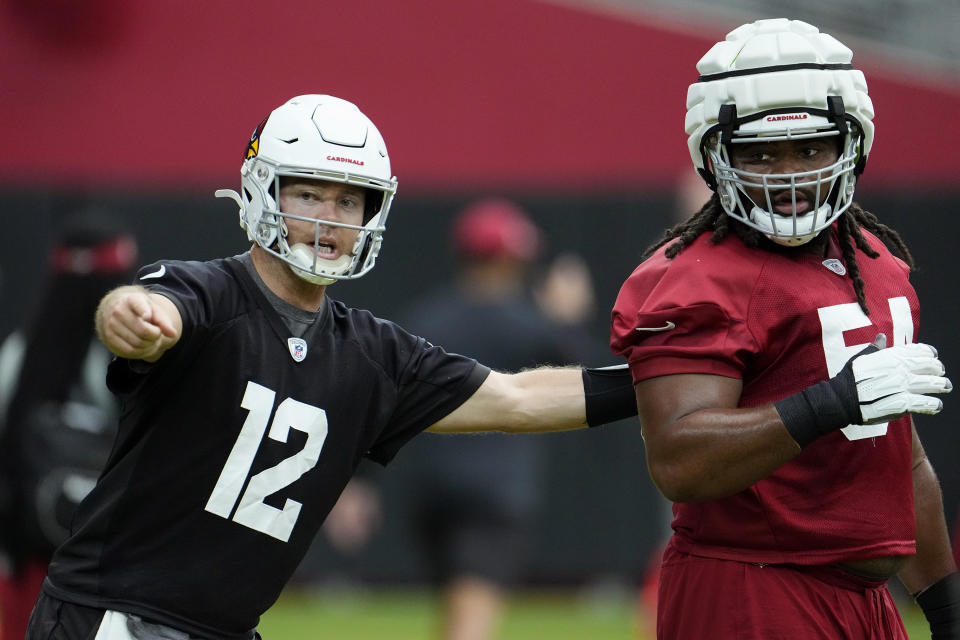 Arizona Cardinals quarterback Colt McCoy (12) tries to direct guard Lecitus Smith during NFL football training camp practice at State Farm Stadium, Monday, Aug. 7, 2023, in Glendale, Ariz. (AP Photo/Ross D. Franklin)